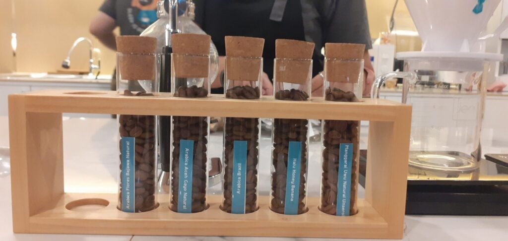 Tabung kaca berisi biji kopi di Paradox Kupang
